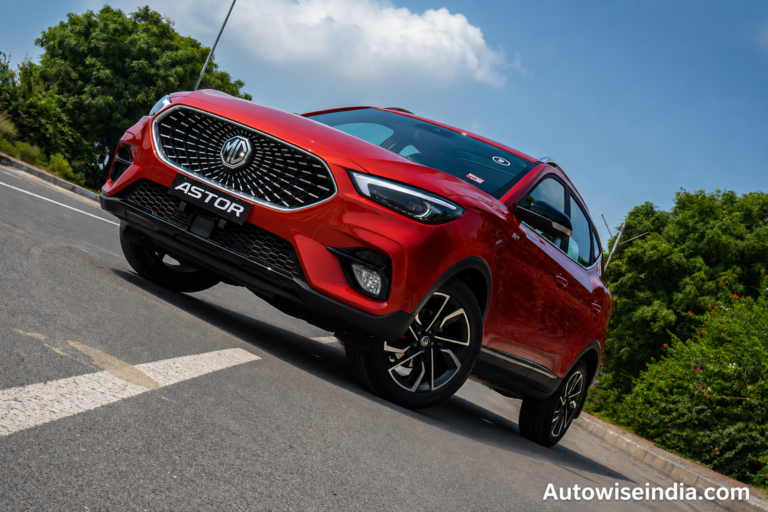 Red MG Astor SUV front profile shot on open road