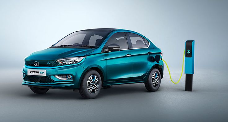Tata Tigor EV electric sedan parked beside a charging station in blue color